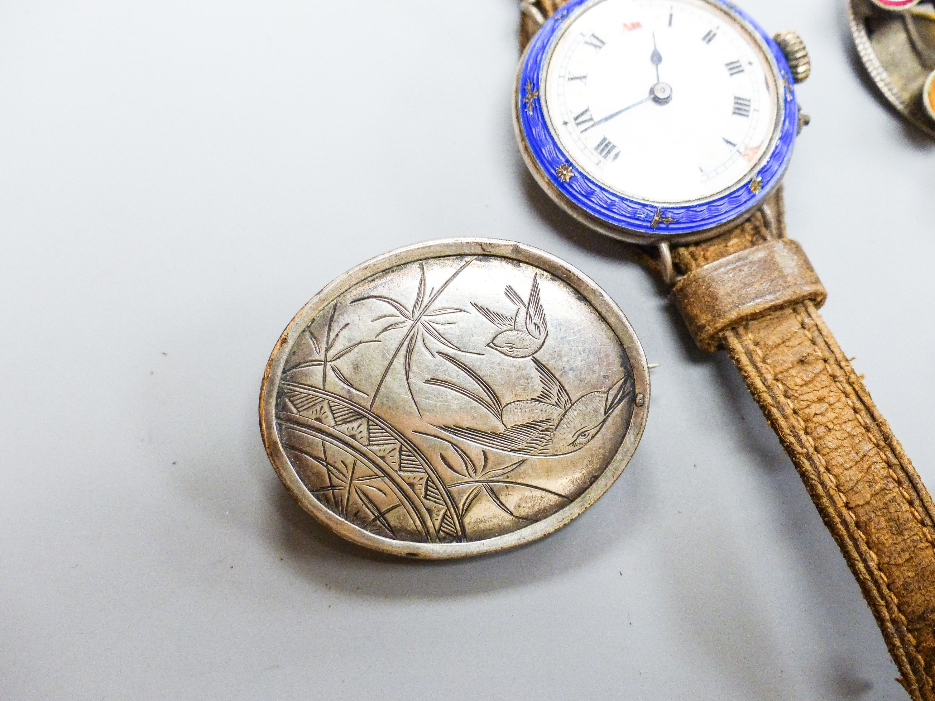 A white metal, paste and enamel set brooch, 40mm, a silver albert, two brooches and a lady's white metal and enamel wrist watch.